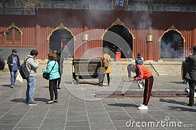 Tourists in the outdoor of a buddhist Chinese temple in Beijing, China, Asia. Editorial Stock Photo
