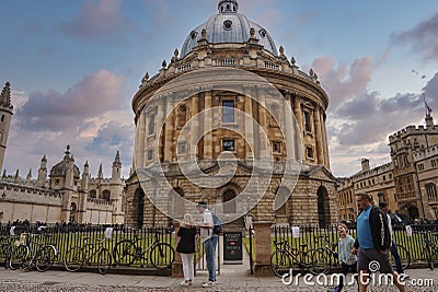 Tourists outside The Radcliffe Camera circular library building at Oxford Editorial Stock Photo