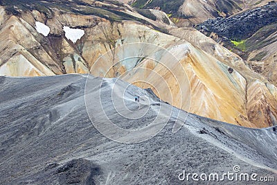 Tourists pass on the slope of the mountain route in Landmannalaugar. Iceland Editorial Stock Photo