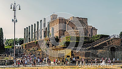 Tourists pass by The Temple of Venus and Roma Editorial Stock Photo