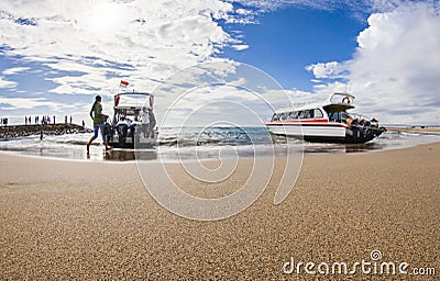 Tourists and passengers take a boat in the port of Sanur to go to Nusa Lembongan, a popular tourist destination in Bali Editorial Stock Photo
