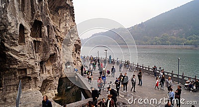 Tourists passing at Long men grottoes Editorial Stock Photo