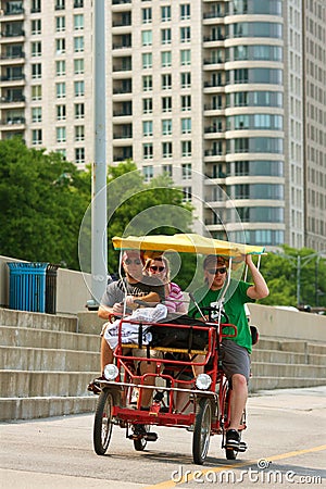 Tourists Pedal Four-Wheeled Cycle Around Chicago Editorial Stock Photo