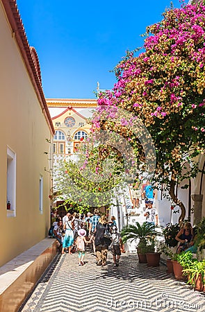 Tourists and pilgrims in the monastery Panormitis. Symi Island Editorial Stock Photo