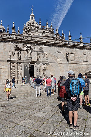 Tourists and pilgrims waiting in line to enter the Holy door of Santiago de Editorial Stock Photo