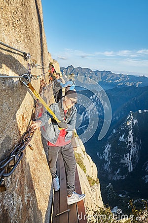 Tourists on the Plank Walk in the Sky, worlds most dangerous hike. Editorial Stock Photo