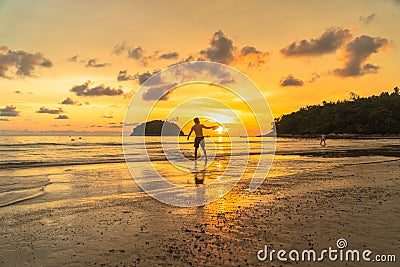 Tourists playing frisbee on the beach in golden sunset Editorial Stock Photo