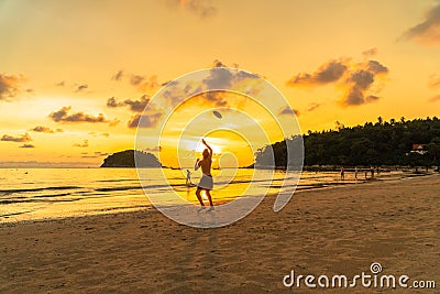 Tourists playing frisbee on the beach in golden sunset Editorial Stock Photo