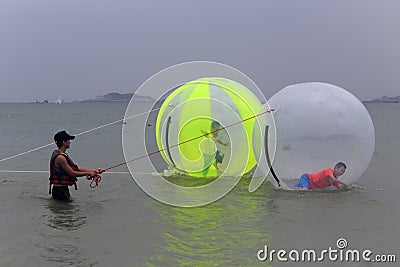 Tourists playing water walking ball at the seaside of dongshan island Editorial Stock Photo