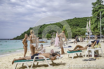 Tourists relax and sunbathe on Haad Tien Beach, a beautiful sandy beach at Koh Larn. Pattaya, Thailand Editorial Stock Photo
