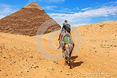 Tourists riding camels near the Pyramid of Khafre, Giza Editorial Stock Photo