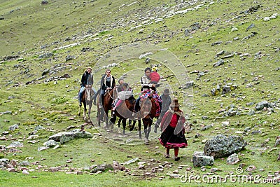Tourists riding horse in Peru green mountain valley Editorial Stock Photo