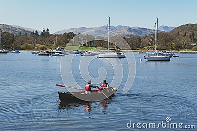 Tourists rowing boat on scenic Lake Windermere in Lake District National Park, North West England, UK Editorial Stock Photo