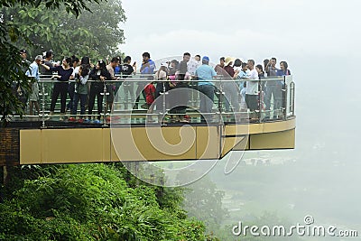 The Tourists are shooting photograph on SkyWalk. SkyWalk is a clear glass walkway to view the Mekong River Editorial Stock Photo