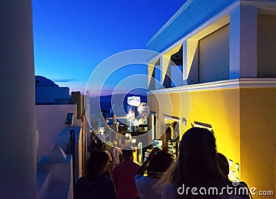 Tourists sightseeing on night streets of Oia town Santorini Greece Editorial Stock Photo