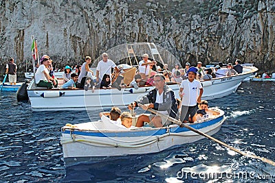 Tourists in small boats waiting to enter the Blue Grotto on Capri Editorial Stock Photo