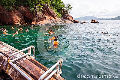 Tourists snorkeling at Red Rock island in Krabi province, Thailand. Editorial Stock Photo