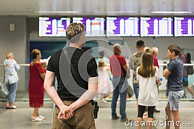 Tourists stand in front of an information Board in the interior of the airport. Blur image of people waiting in front of airport Editorial Stock Photo