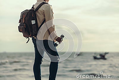Tourists stand to watch sea sunset. backpacker, travel concept Stock Photo