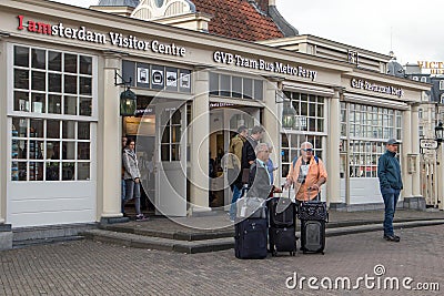 Tourists standing with suitcases outside tourist information visitor centre Editorial Stock Photo