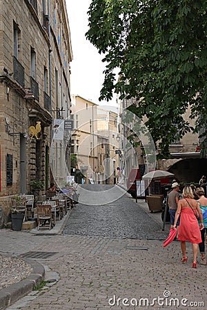 Tourists strolling in the central square of the french city of Pezenas, France Editorial Stock Photo