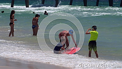 Tourists swimming at the beach Editorial Stock Photo