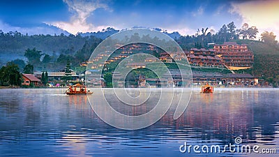 Tourists take a boat at Ban Rak Thai village in Mae Hong Son province, Thailand Stock Photo