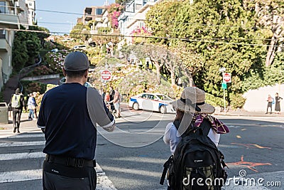 Tourists take pictures at the entrance of the most winding part of Lombardt Street in San Francisco, California, USA Editorial Stock Photo