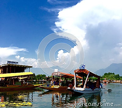 Tourists take a ride on a Shikara at Dal Lake in Kashmir India Editorial Stock Photo