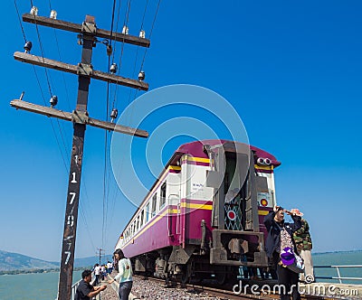 Tourists taking photograph near vintage train and electricity po Editorial Stock Photo