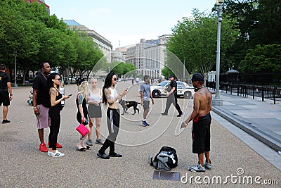 Tourists taking Photos from a Homeless Man in front of White House. Washington DC Editorial Stock Photo