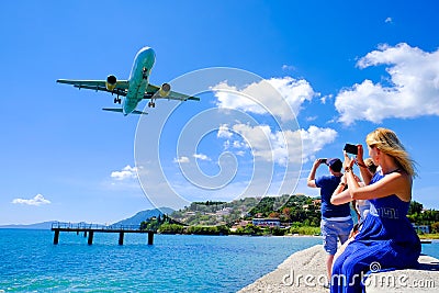 Tourists taking pictures in Corfu. Plane landing Editorial Stock Photo