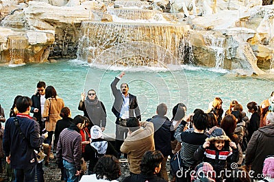 Tourists throwing coins in Fontana di Trevi, Rome Editorial Stock Photo