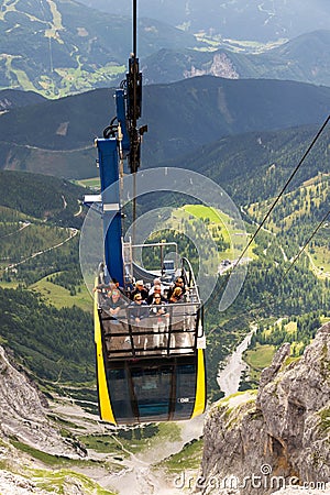 Tourists on top of gondola in the upper station of the Dachstein cable car on August 17, 2017 in Ramsau am Dachstein, Austria. Editorial Stock Photo