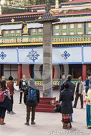 Tourists toss many coin to the top of stone pillar for lucky in the center of Rumtek Monastery in winter near Gangtok. Sikkim Editorial Stock Photo