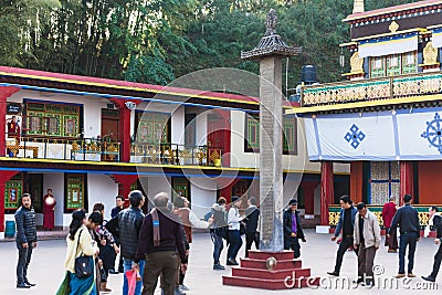 Tourists toss many coin to the top of stone pillar for lucky in the center of Rumtek Monastery in winter near Gangtok. Sikkim Editorial Stock Photo