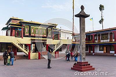 Tourists toss many coin to the top of stone pillar for lucky in the center of Rumtek Monastery in winter near Gangtok. Sikkim Editorial Stock Photo