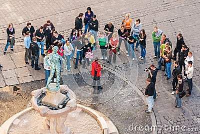 Tourists with the tourist guide gathered in front of the Statue of The Naked Fencer, Wroclaw Editorial Stock Photo