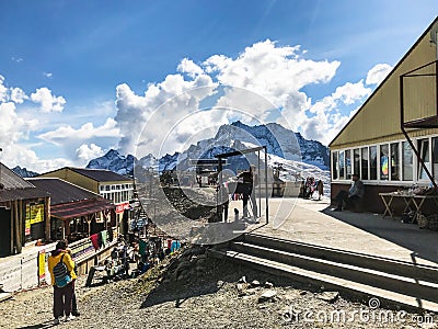 Tourists on upper station of aerial lift in Dombay Editorial Stock Photo