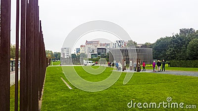 Tourists visiting the arranged remains of the Berlin wall Editorial Stock Photo