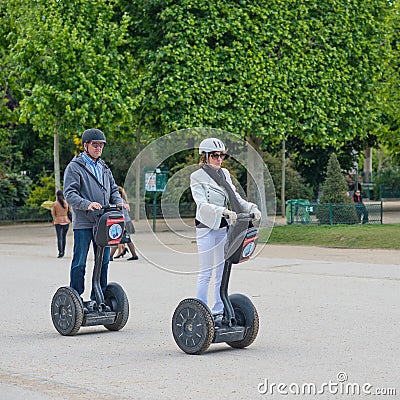 Tourists visiting the city near the Eiffel Tower during their guided Segway tour of Paris. Editorial Stock Photo