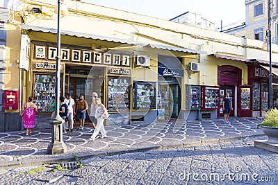 Tourists visiting a shopping street with souvenir shops Editorial Stock Photo