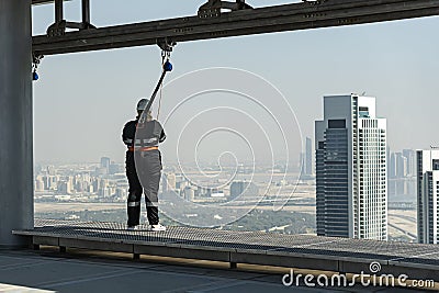 tourists walk along the edge of the roof of a skyscraper on the Sky View skyscraper. Dangerous scary attraction. Stock Photo