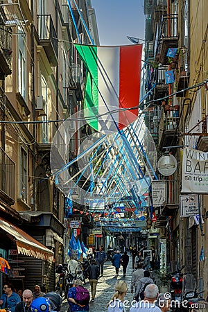 Tourists walk along narrow alley in old town Naples, Italy. Editorial Stock Photo