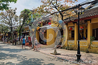 Tourists walk along the street in Ho An old town area. Editorial Stock Photo
