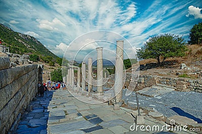 Tourists walk down the Street of Curetes towards the Library of Celsus Editorial Stock Photo