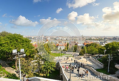 Tourists walk the long staircase from the Buda Castle Complex, with the Parliament Building and Danube River in view below Editorial Stock Photo