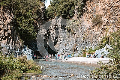 Tourists walking in Alcantara Gorge and Alcantara river park in Sicily Island, Italy. Editorial Stock Photo