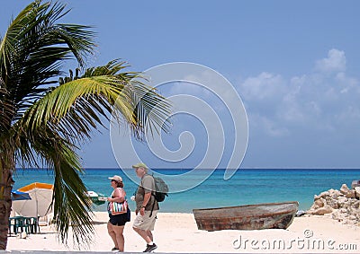 Tourists walking on beach Stock Photo