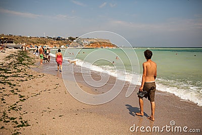 Tourists walking on the beach Editorial Stock Photo